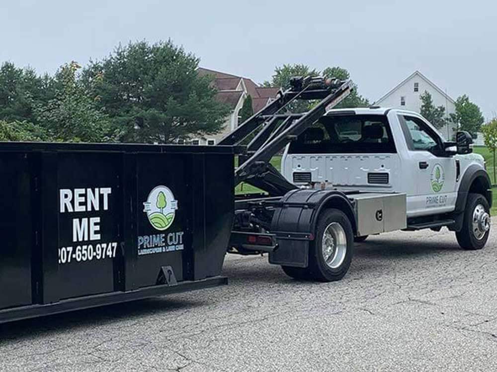 prime cut dumpster rolling off truck